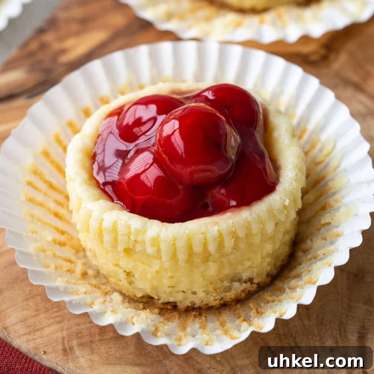 Mini Cherry Cheesecake Bites: Perfect Party Dessert Recipe 2 mini cherry cheesecake in a cupcake liner.