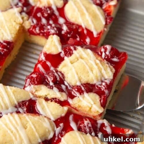 slice of cherry coffee cake in a pan.