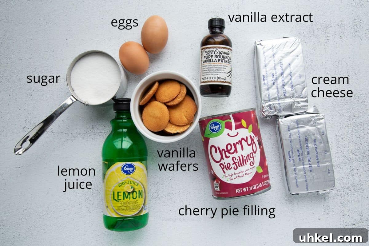 Mini Cherry Cheesecake Bites: Perfect Party Dessert Recipe 3 nilla wafers, cherry pie filling, cream cheese, and more ingredients on a white table.