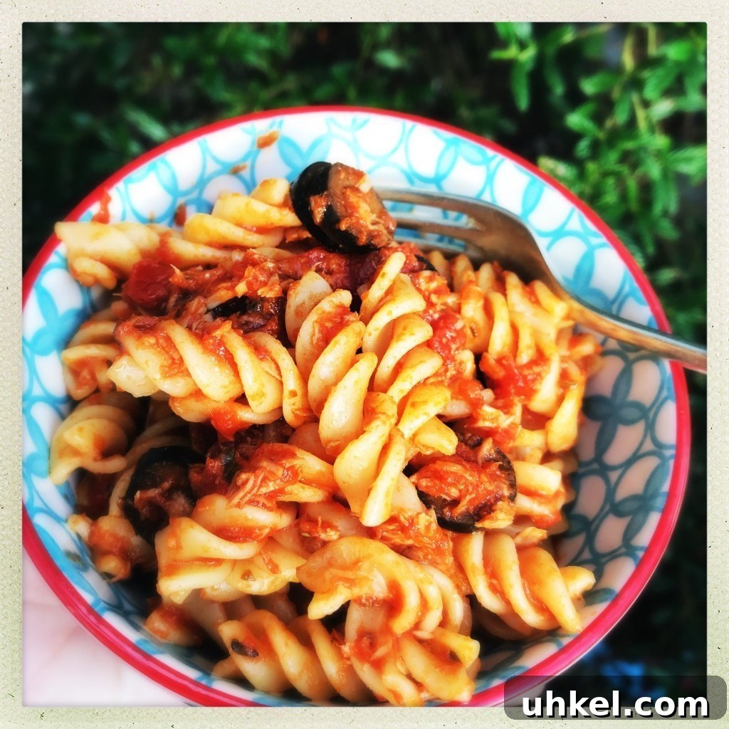 30-Minute Family Dinner Recipes Your Whole Family Will Love 6 red and blue bowl filled with homemade tuna bolognese with fusilli pasta