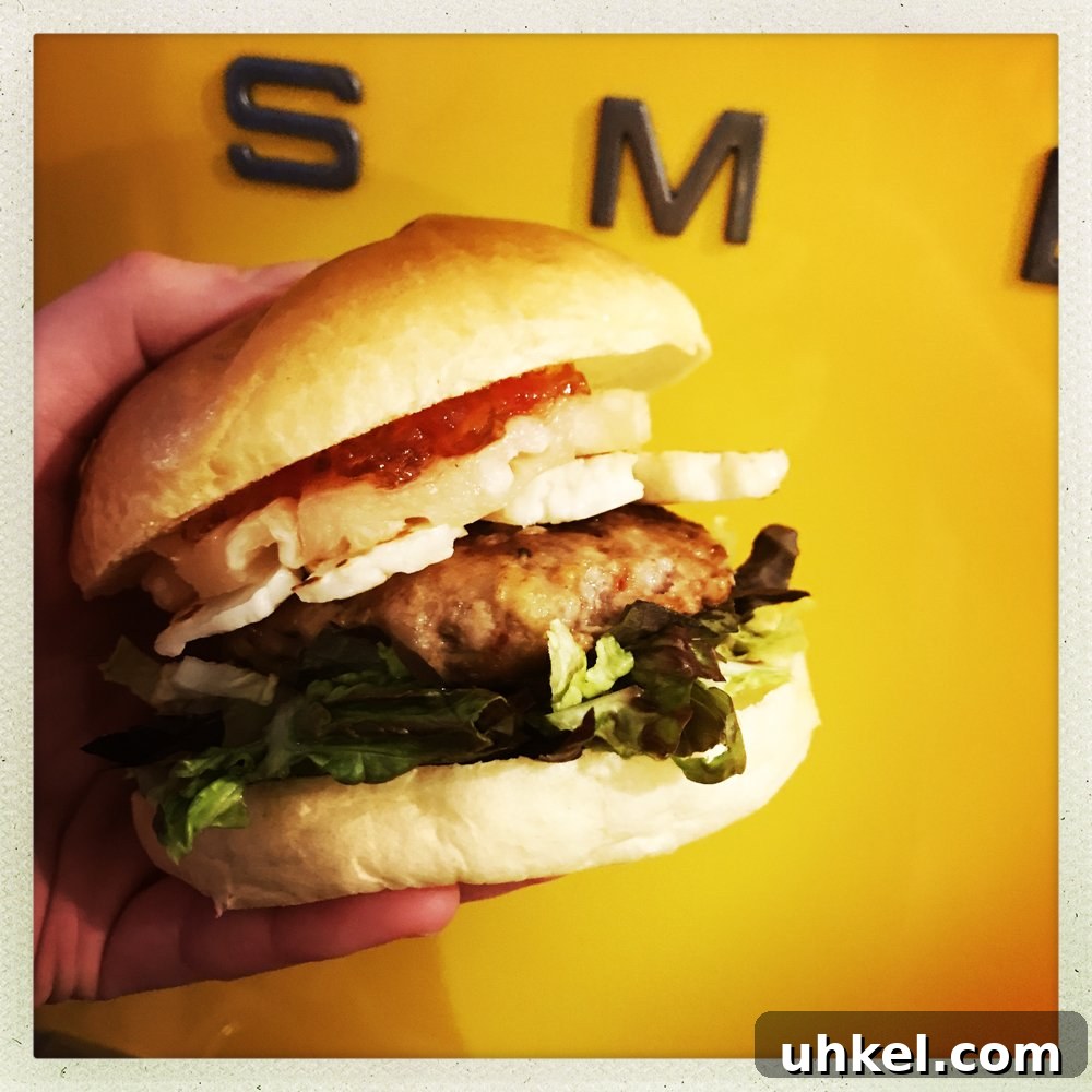 30-Minute Family Dinner Recipes Your Whole Family Will Love 7 Homemade turkey burger on brioche roll with salad, pineapple and halloumi alongside sweet potato fires. Yellow SMEG fridge in the background