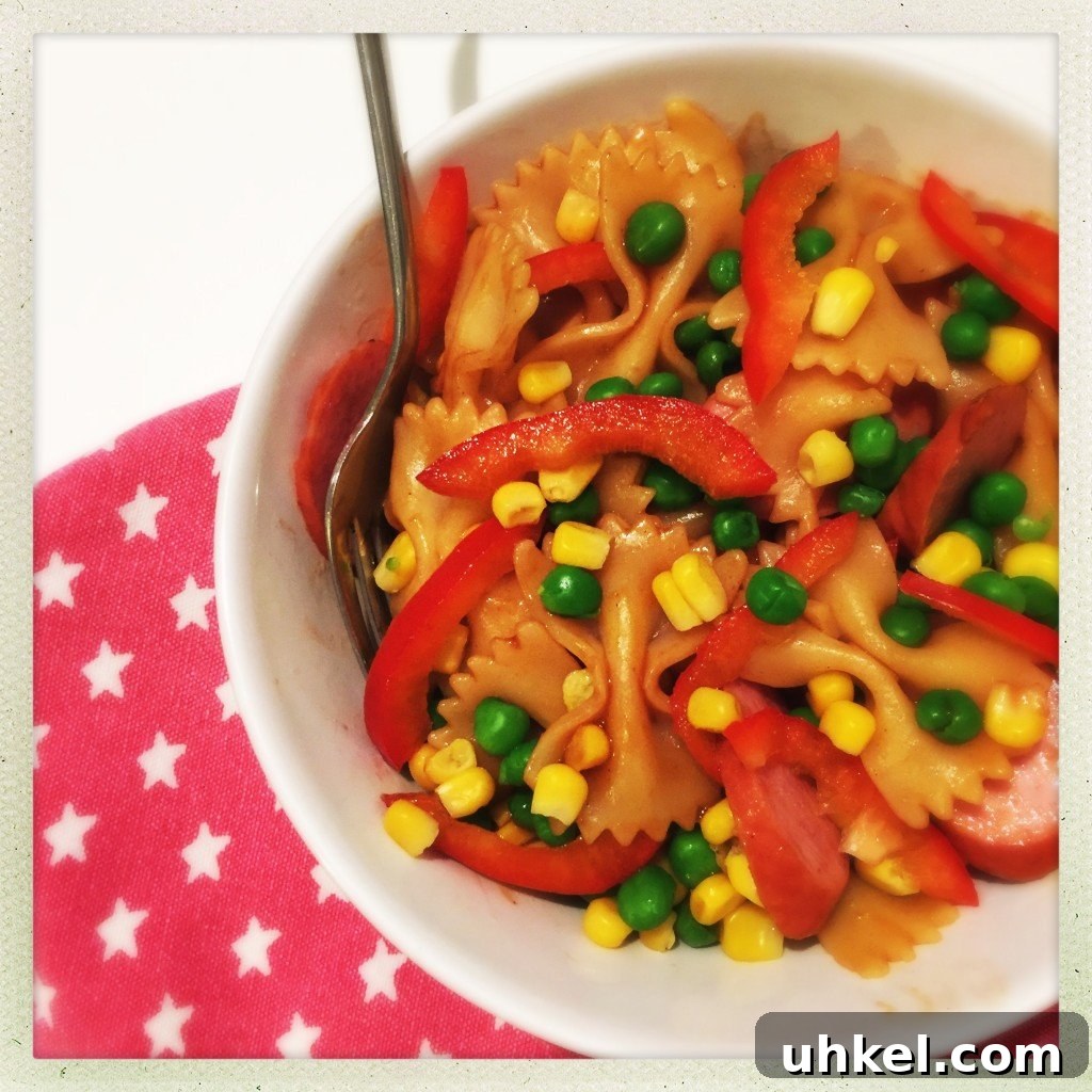 30-Minute Family Dinner Recipes Your Whole Family Will Love 21 bowlful of homemade bbq pasta with sausage, sweetcorn, peas and peppers