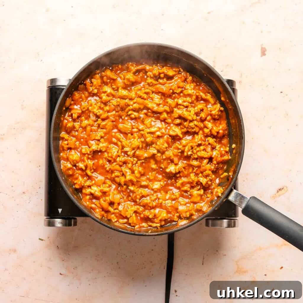 Ground Turkey-Style Sloppy Joes with Ground Chicken 6 simmering sloppy Joe mixture in pan.