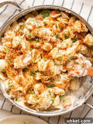 pan of tuna noodle casserole with wooden spoon.