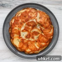 Classic Pommes Anna: Crispy French Layered Potato Cake 3 Golden baked scalloped potatoes layered with cheese.