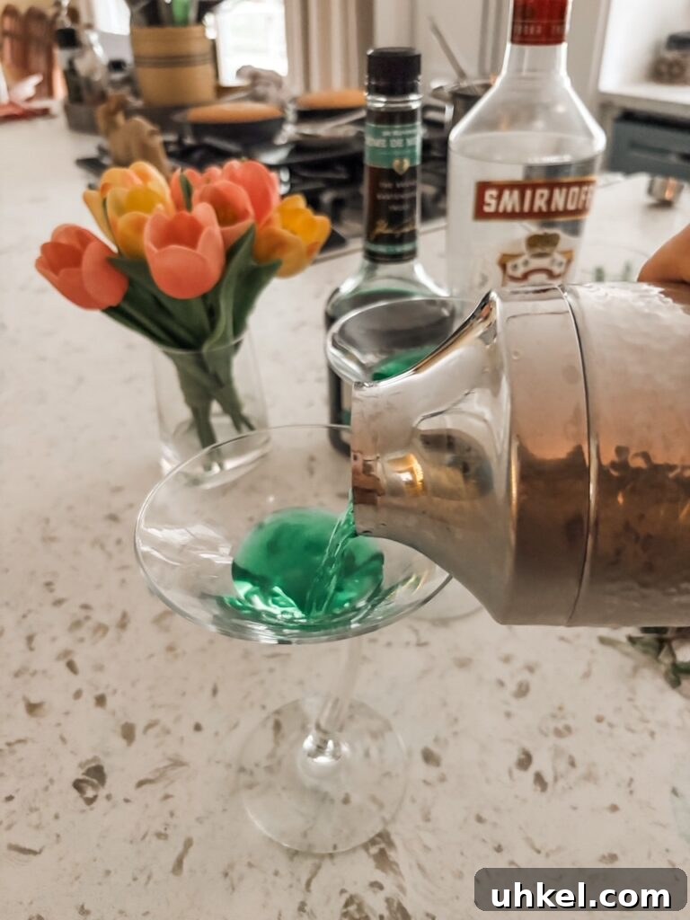 60s Vodka Stinger Cocktail & Mocktail Recipe — Book Club Pick 4 The shaker pouring out the finished classic 60s cocktail