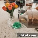 The shaker pouring out the finished classic 60s cocktail