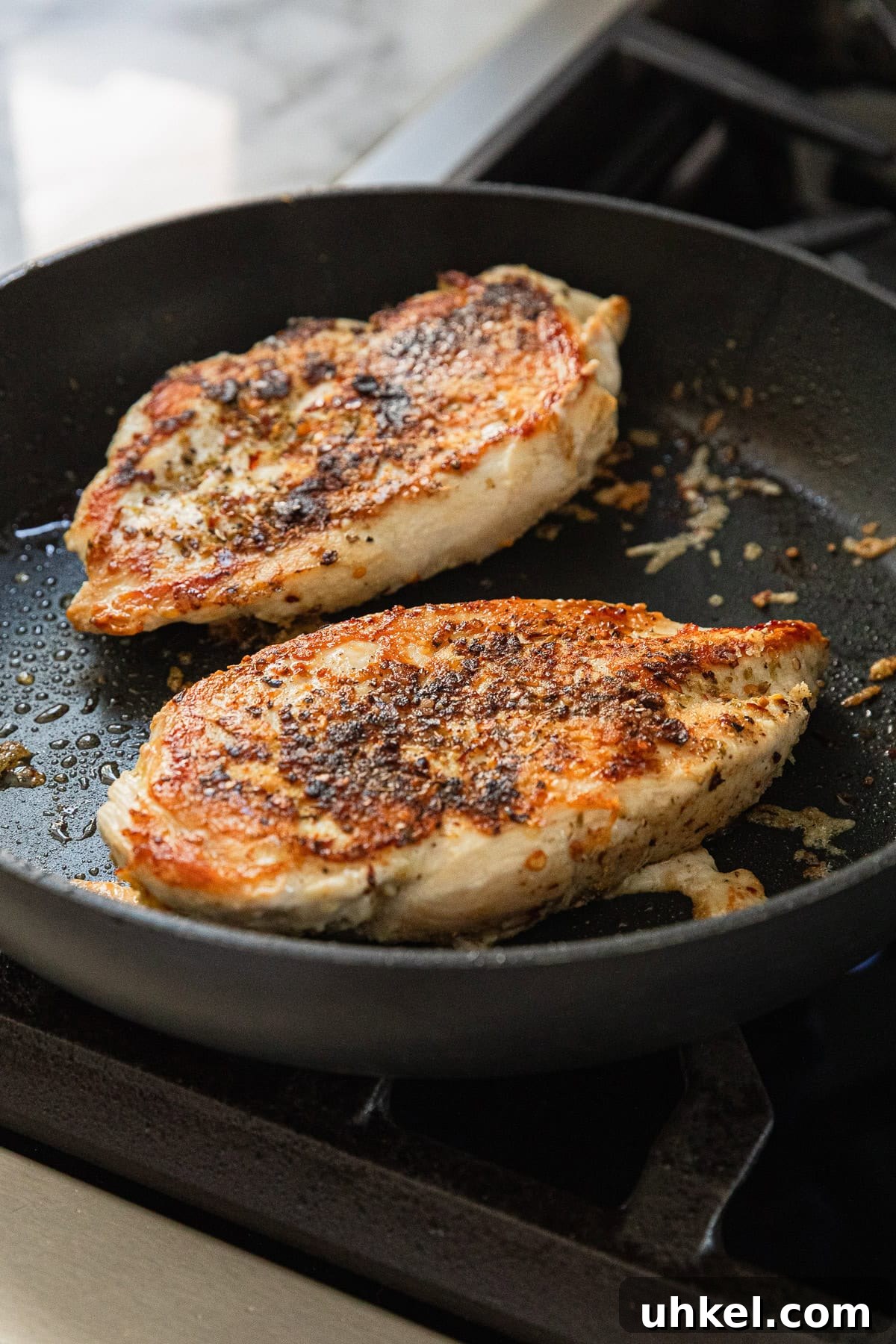 Olive Garden Chicken and Broccoli Copycat Recipe 5 Cooking chicken breast in a skillet.