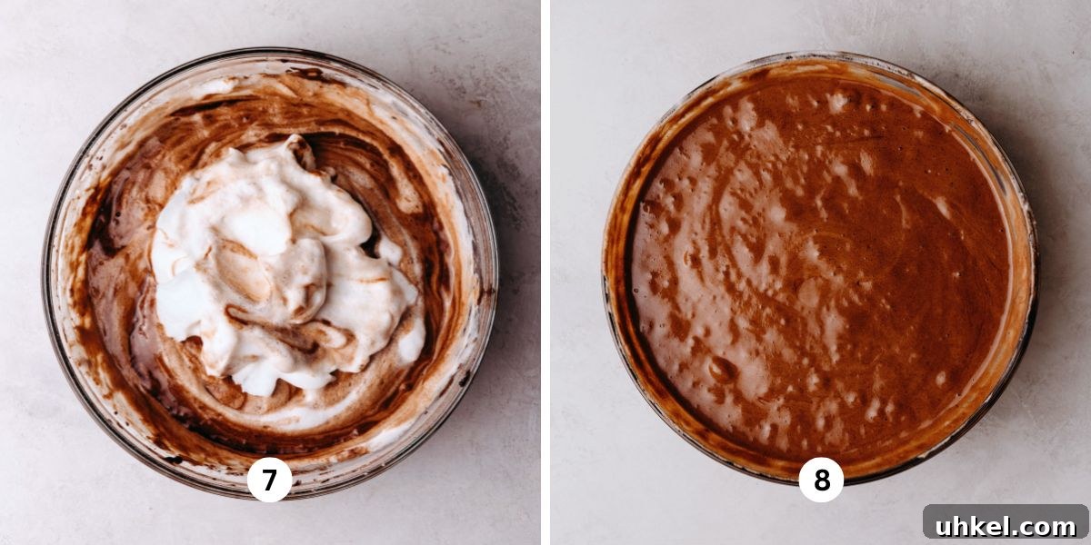 Moist Chocolate Chiffon Cake Recipe for Light, Fluffy Dessert 8 Folding meringue into chocolate chiffon cake batter in a large glass bowl on a white marbled background.