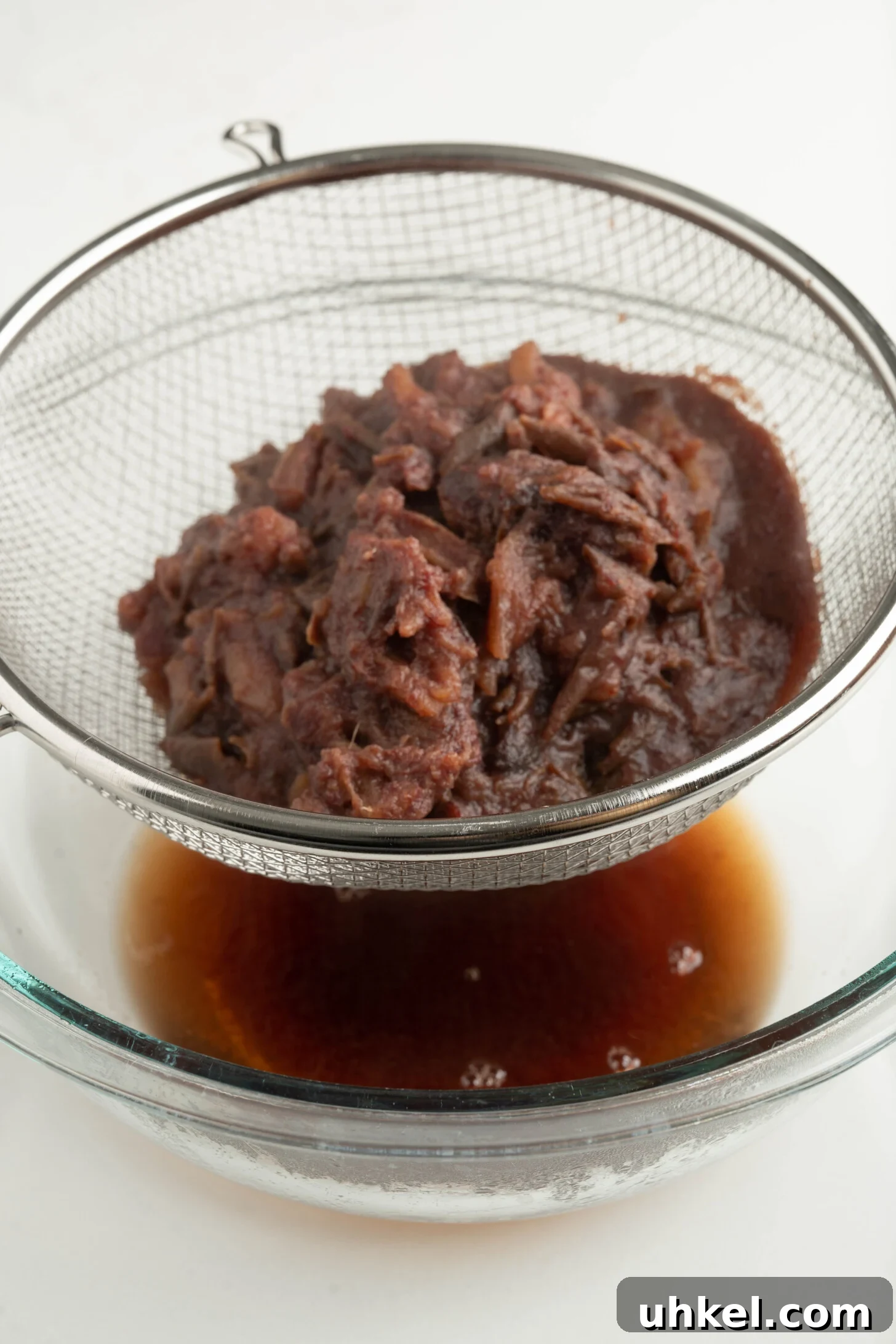 date pulp straining into a bowl