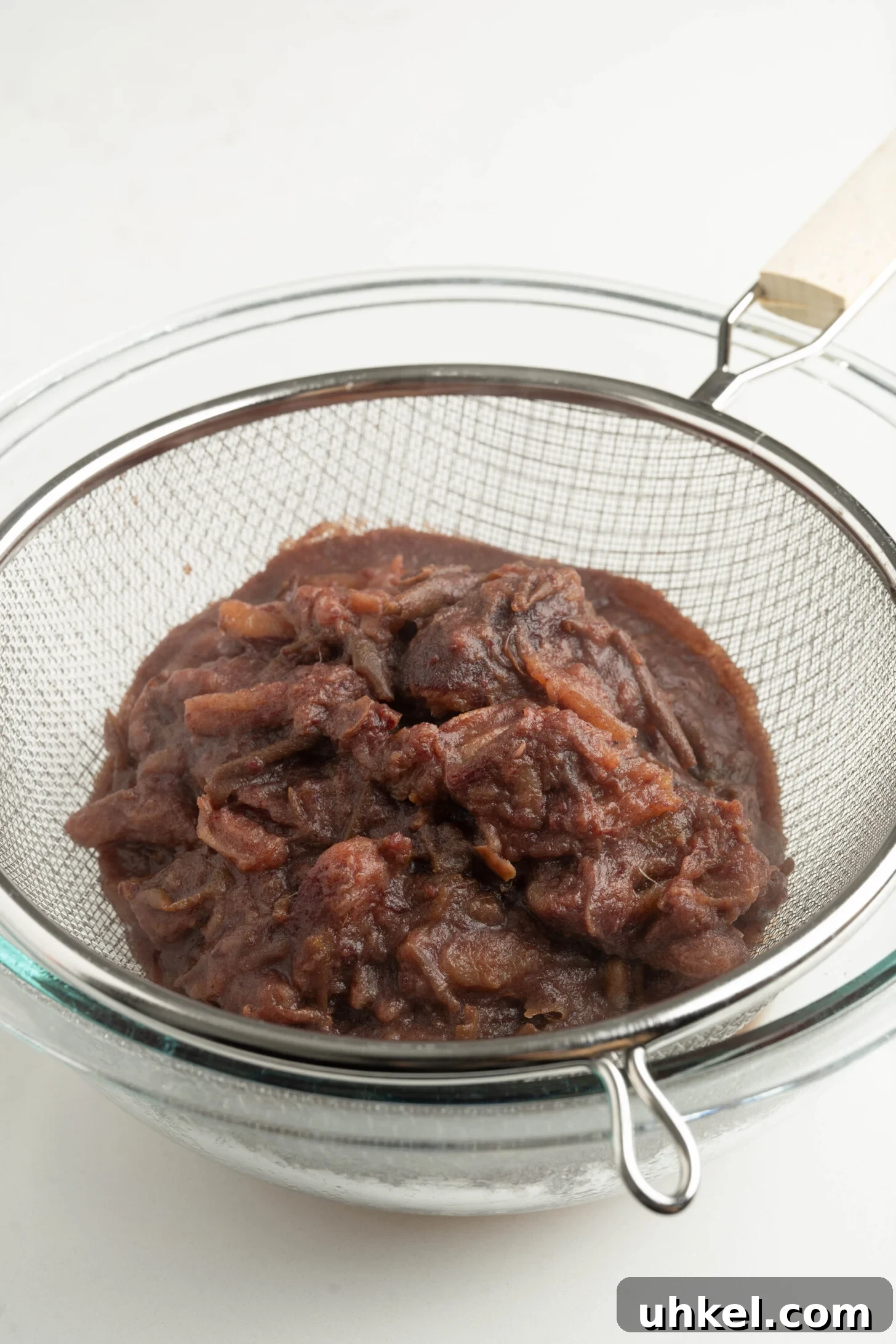 date pulp straining into a bowl