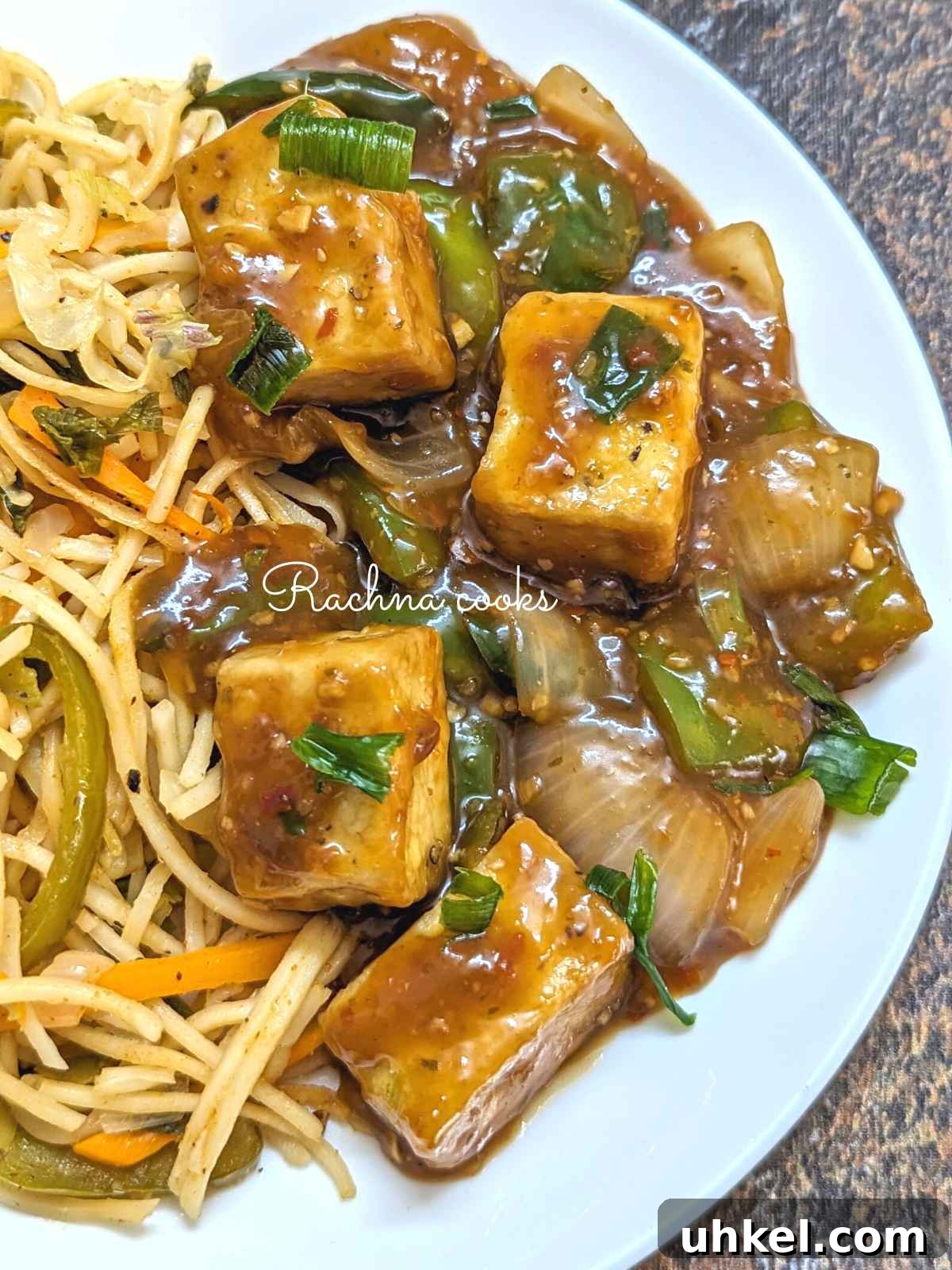 Crispy Tofu Manchurian with Spicy Indo-Chinese Sauce 2 Tofu manchurian served with noodles on a white plate.