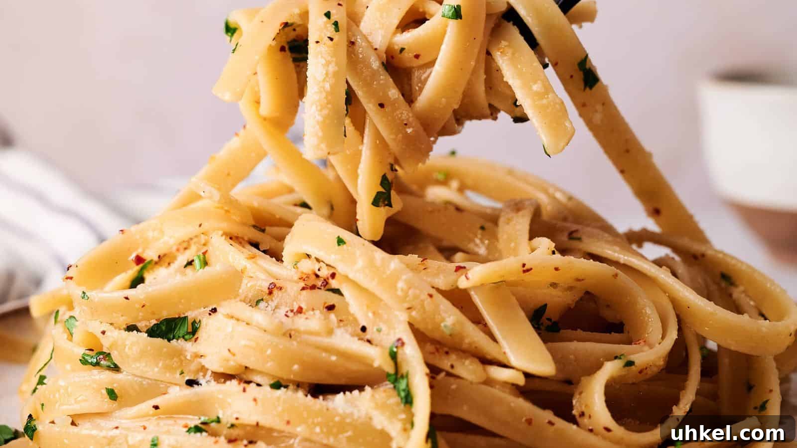 23 Spring Dinner Recipes to Lighten Up Heavy Weeknight Meals 16 Close-up of fettuccine pasta tossed with grated cheese, chopped parsley, and red pepper flakes being lifted with a fork.