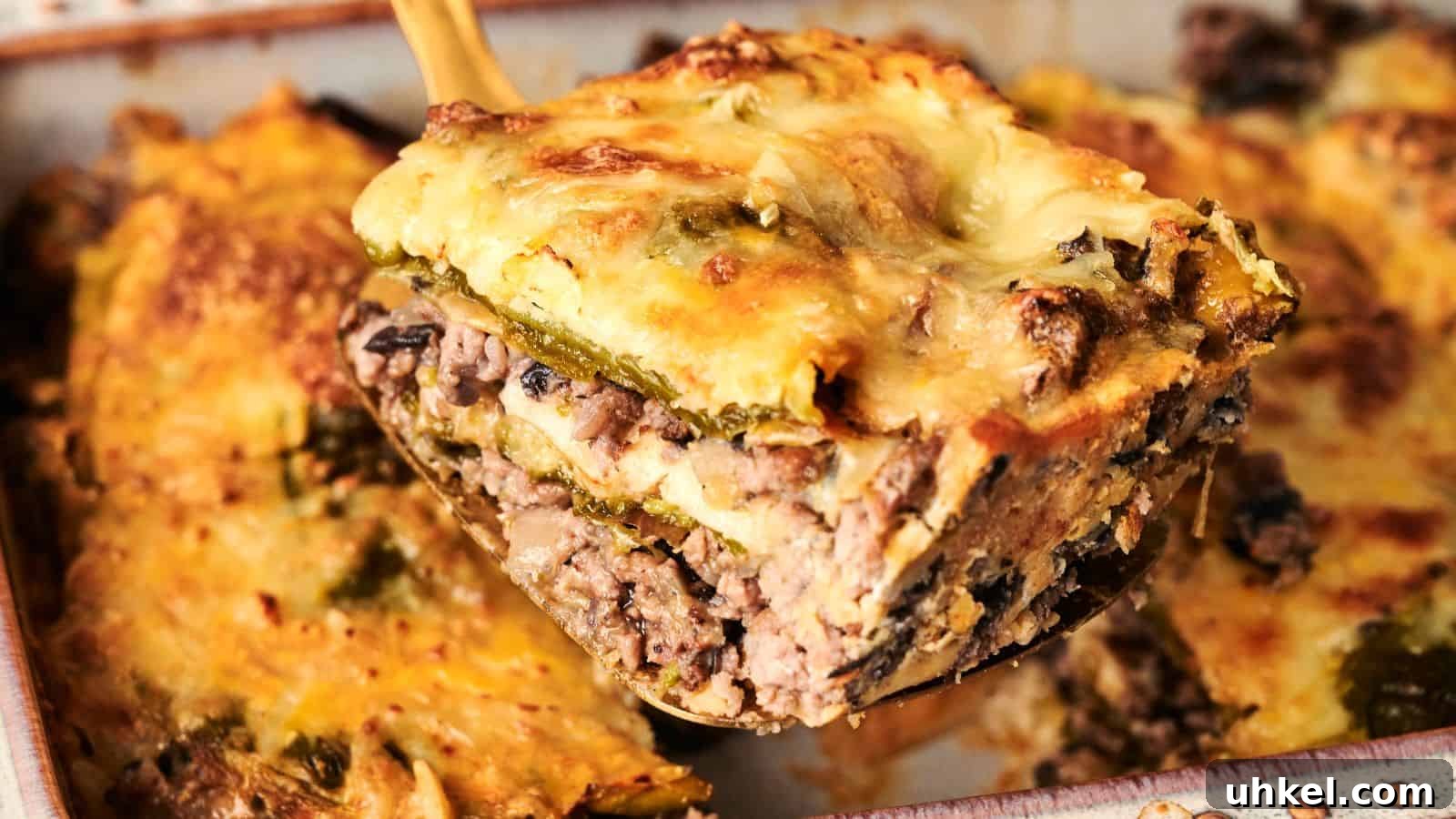 23 Spring Dinner Recipes to Lighten Up Heavy Weeknight Meals 19 A slice of lasagna with beef, mushrooms, cheese, and vegetables being lifted from a baking dish.