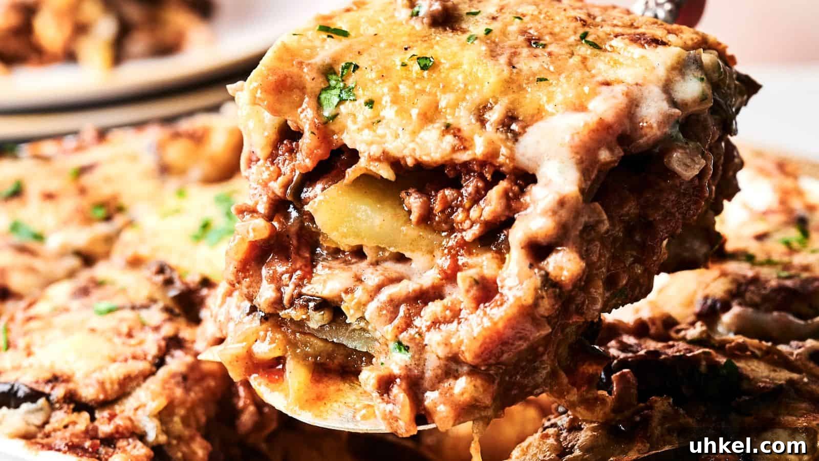 23 Spring Dinner Recipes to Lighten Up Heavy Weeknight Meals 5 A close-up of a serving of cheesy baked lasagna with visible layers of pasta, meat sauce, and melted cheese.