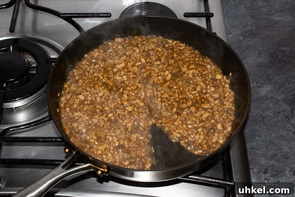 Cooked vegetarian mince and onion pie filling in a frying pan