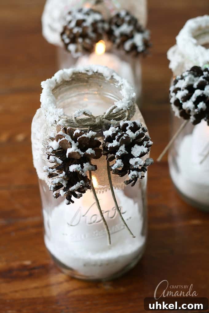 31 Cozy Winter Home Decor Ideas to Refresh Every Room 14 snowy pinecone candle jars