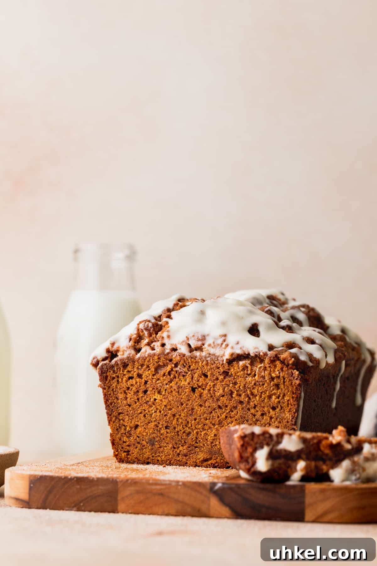 Pumpkin Bread with Cream Cheese Frosting Recipe and Tips 2 Pumpkin bread with cream cheese frosting on a wood board.