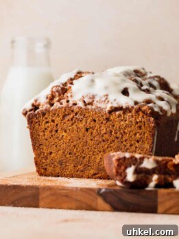 Pumpkin Bread with Cream Cheese Frosting Recipe and Tips 12 Pumpkin bread with cream cheese frosting on a wood board.