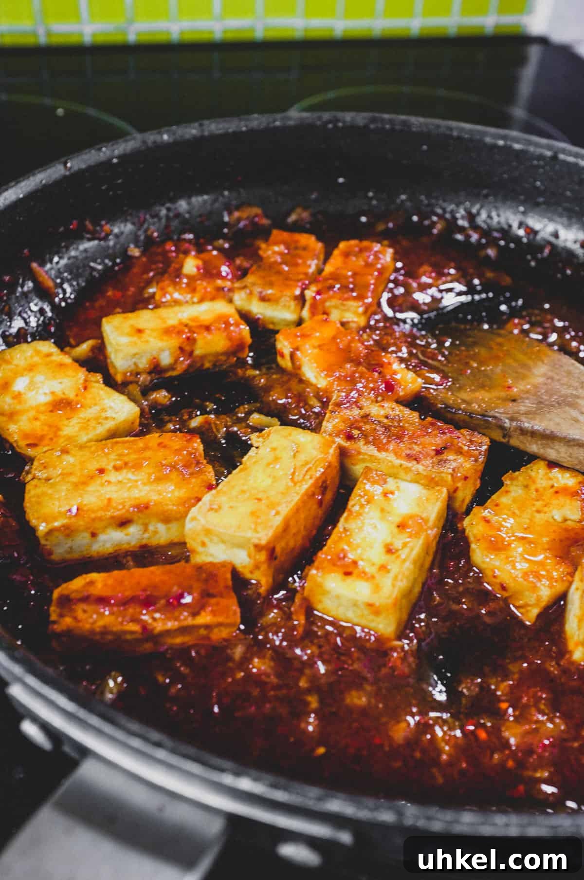 Fried tofu is lightly braised in Korean chilli (gochugaru)