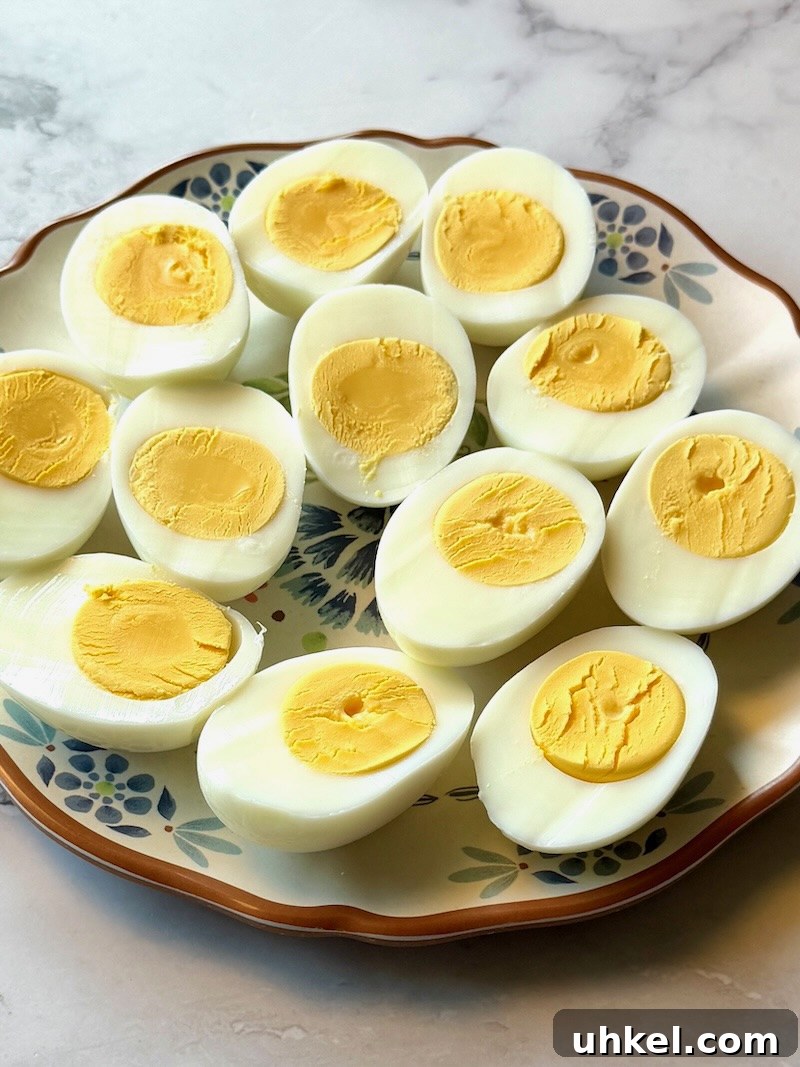 Classic Deviled Eggs Recipe for Gatherings 8 Hard boiled eggs sliced in half on a plate
