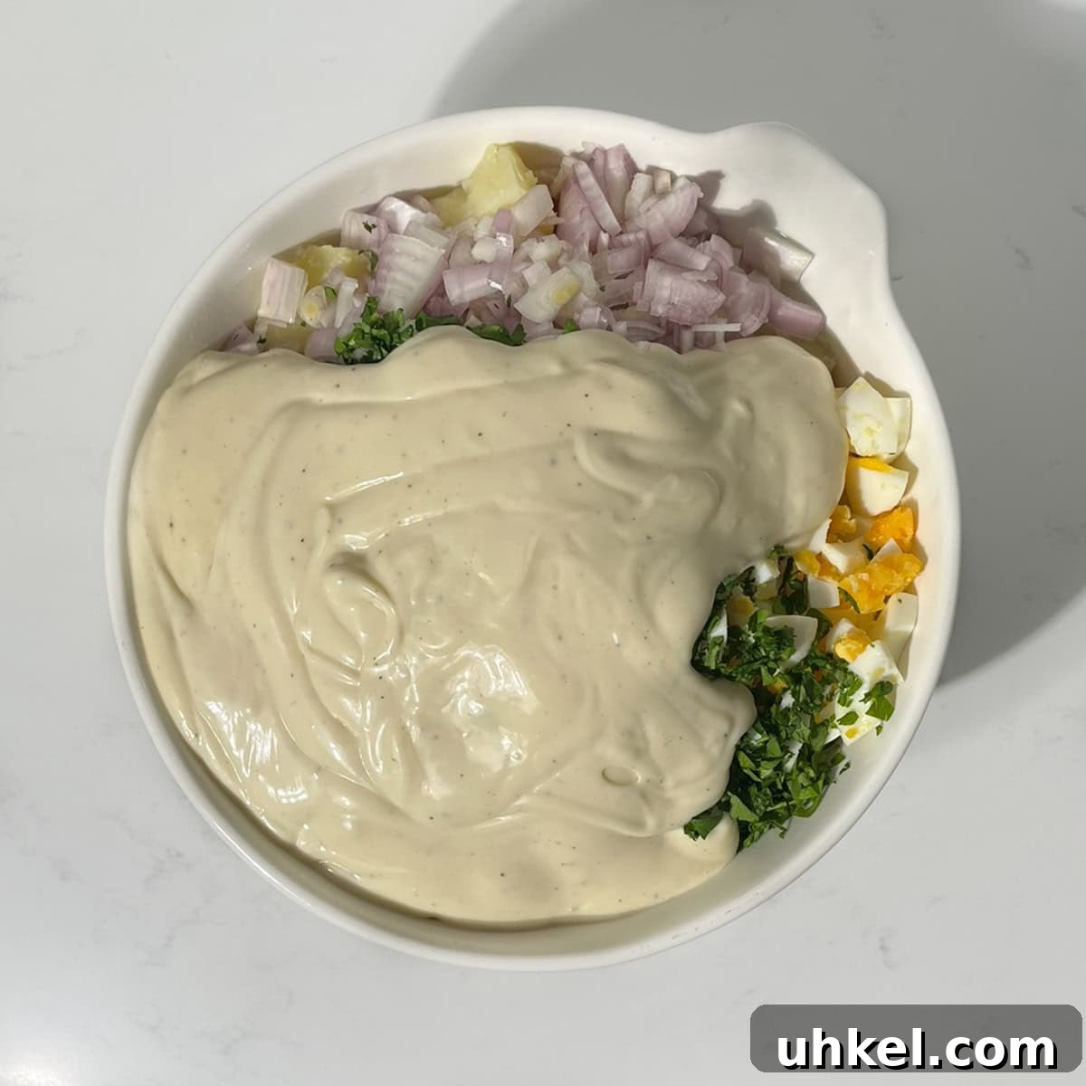 Creamy Potato Salad with Sweetened Condensed Milk Recipe 8 Adding the condensed milk dressing to the South African potato salad.