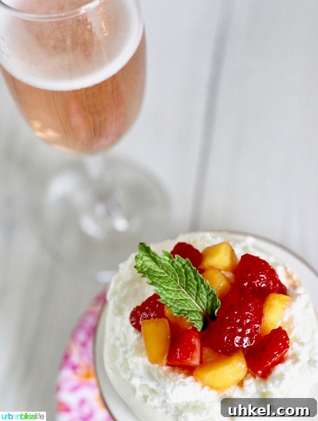 Strawberry & Peach Mini Pavlovas with Whipped Cream 12 Pavlova Mini Cakes with Strawberries, Peaches, and Cream recipe on UrbanBlissLife.com