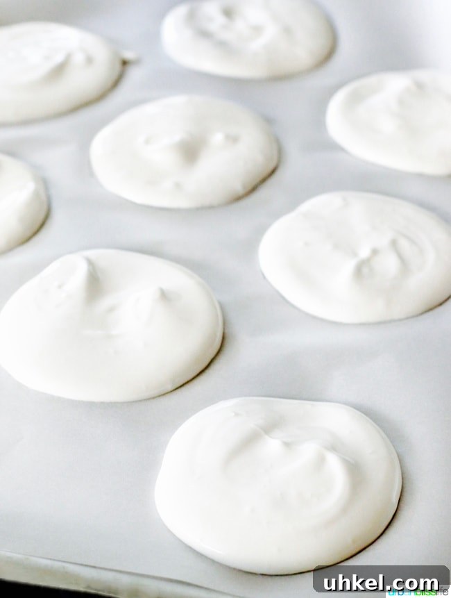 Strawberry & Peach Mini Pavlovas with Whipped Cream 6 meringues on baking sheet