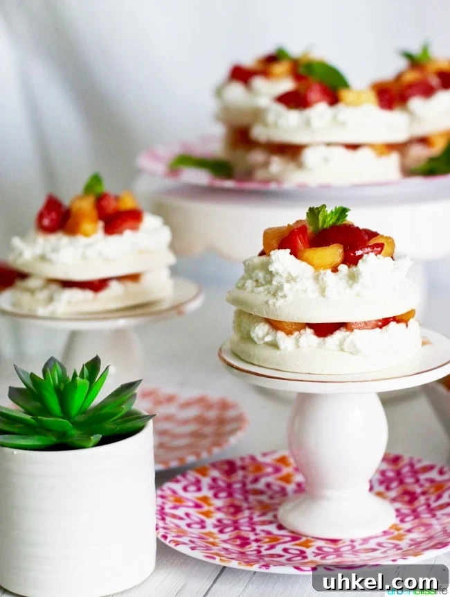 Strawberry & Peach Mini Pavlovas with Whipped Cream 7 Mini Pavlova Cakes with Strawberries, Peaches, and Cream recipe on UrbanBlissLife.com