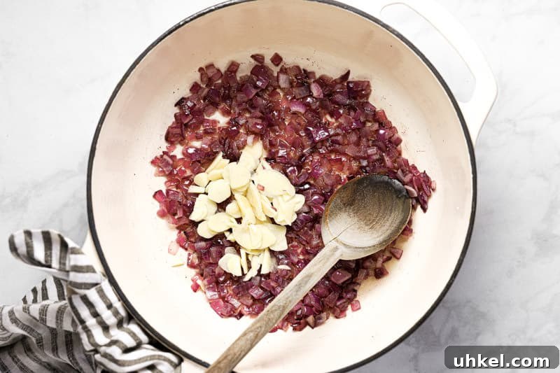 Large white pot with sauteed onion and garlic 