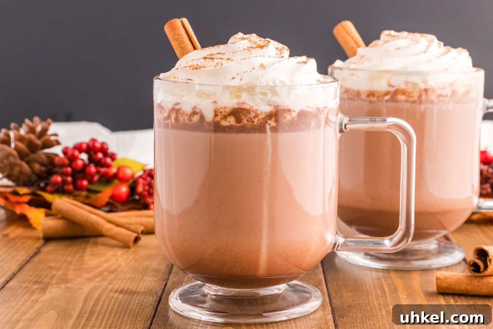 Authentic Mexican Hot Chocolate Recipe – Rich, Spiced Cocoa 3 Two glasses of Mexican hot chocolate with cinnamon sticks and whipped cream.