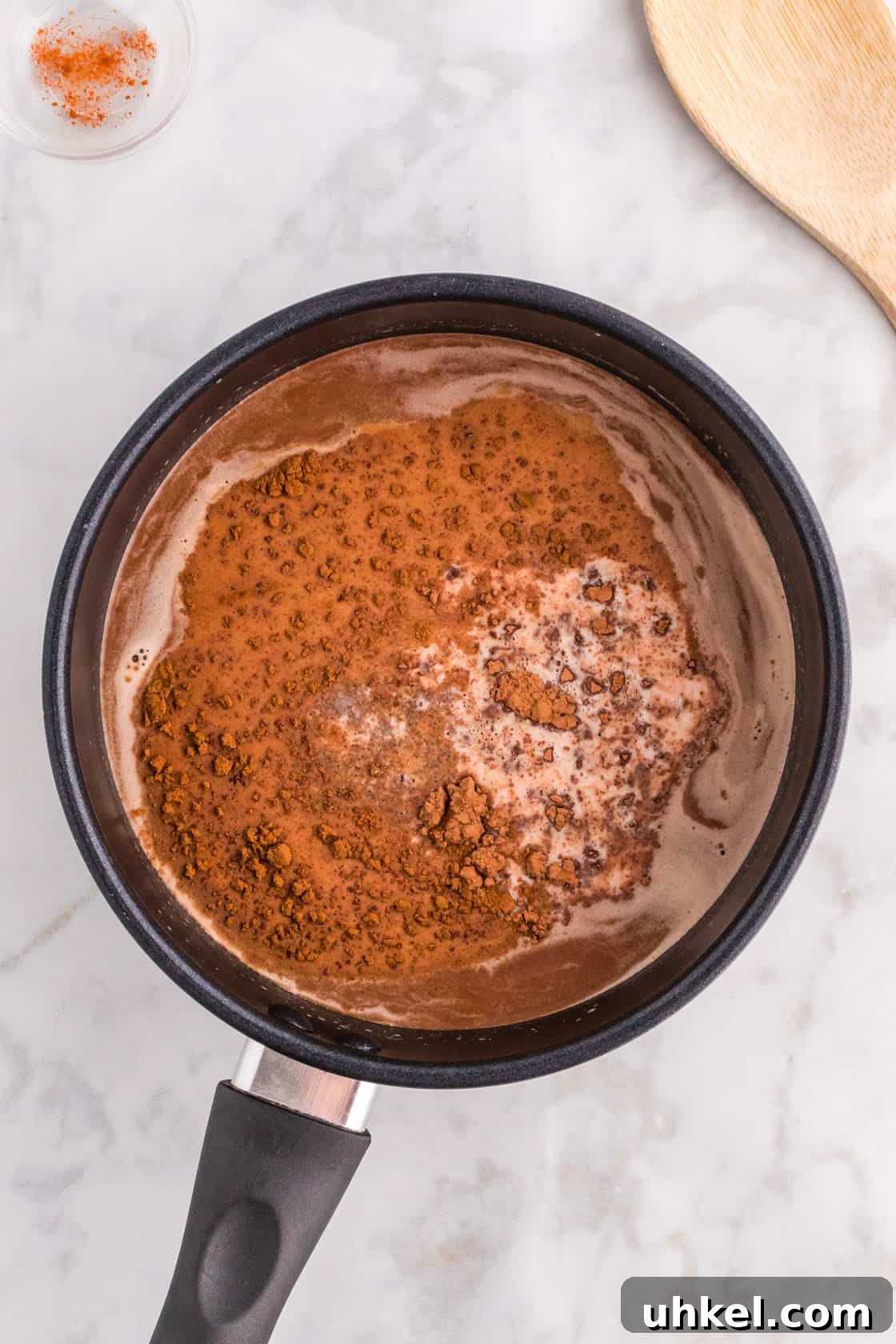Authentic Mexican Hot Chocolate Recipe – Rich, Spiced Cocoa 7 Cocoa powder in a pan with milk and chocolate chips