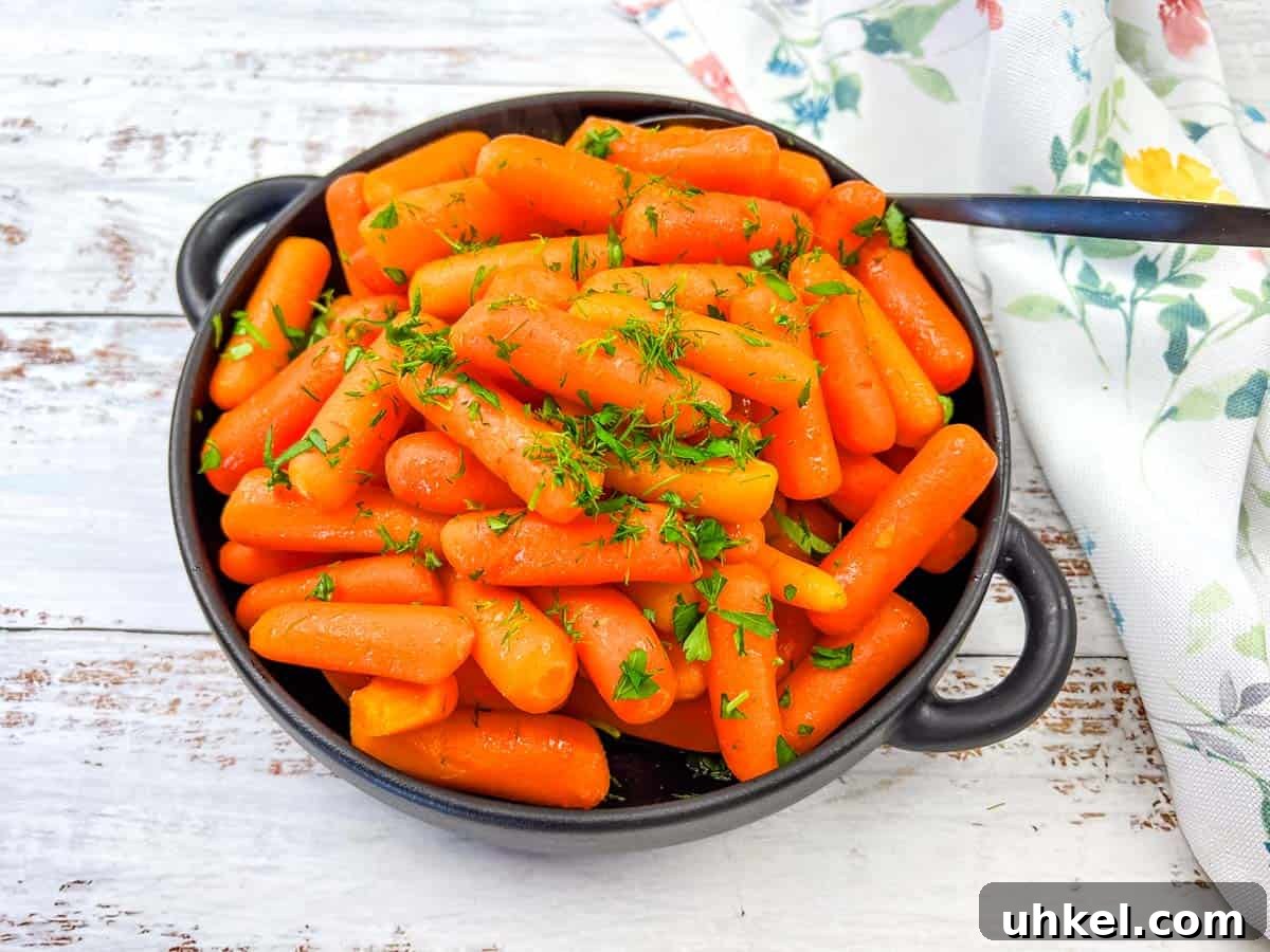 35 Timeless Southern Recipes That Always Delight 19 Copycat Cracker Barrel Baby Carrots in a white bowl.