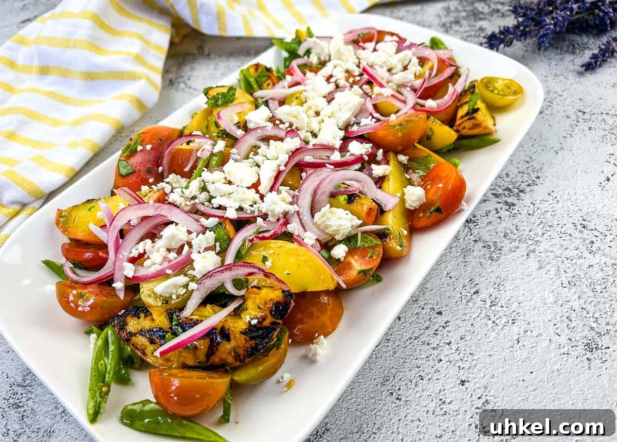 35 Timeless Southern Recipes That Always Delight 26 A plate with Grilled Peach Salad with Tomatoes.