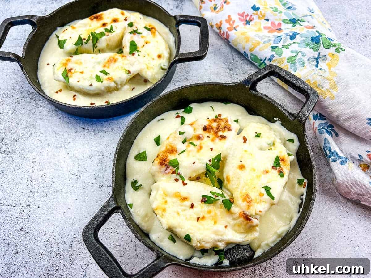 35 Timeless Southern Recipes That Always Delight 31 Giant Cheese Stuffed Pasta Shells in two black serving dishes.