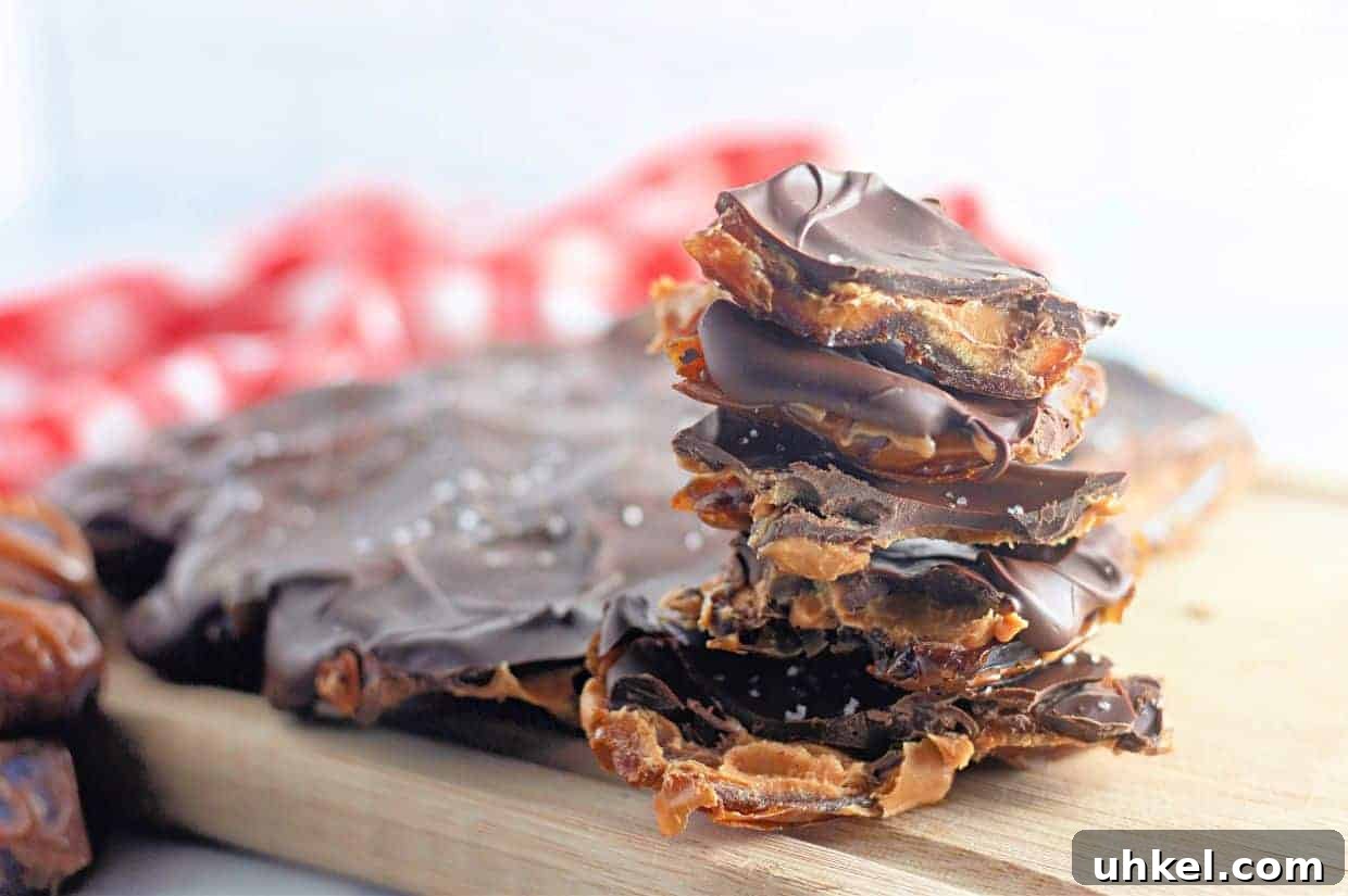 35 Timeless Southern Recipes That Always Delight 33 A stack of Peanut Butter and Date Chocolate Bark pieces sits on a wooden board.