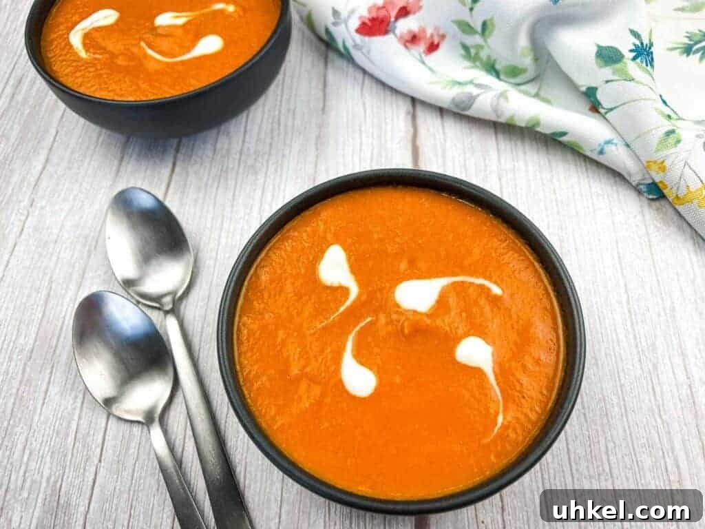 35 Timeless Southern Recipes That Always Delight 10 Two bowls of oven-roasted tomato soup with cream swirls.