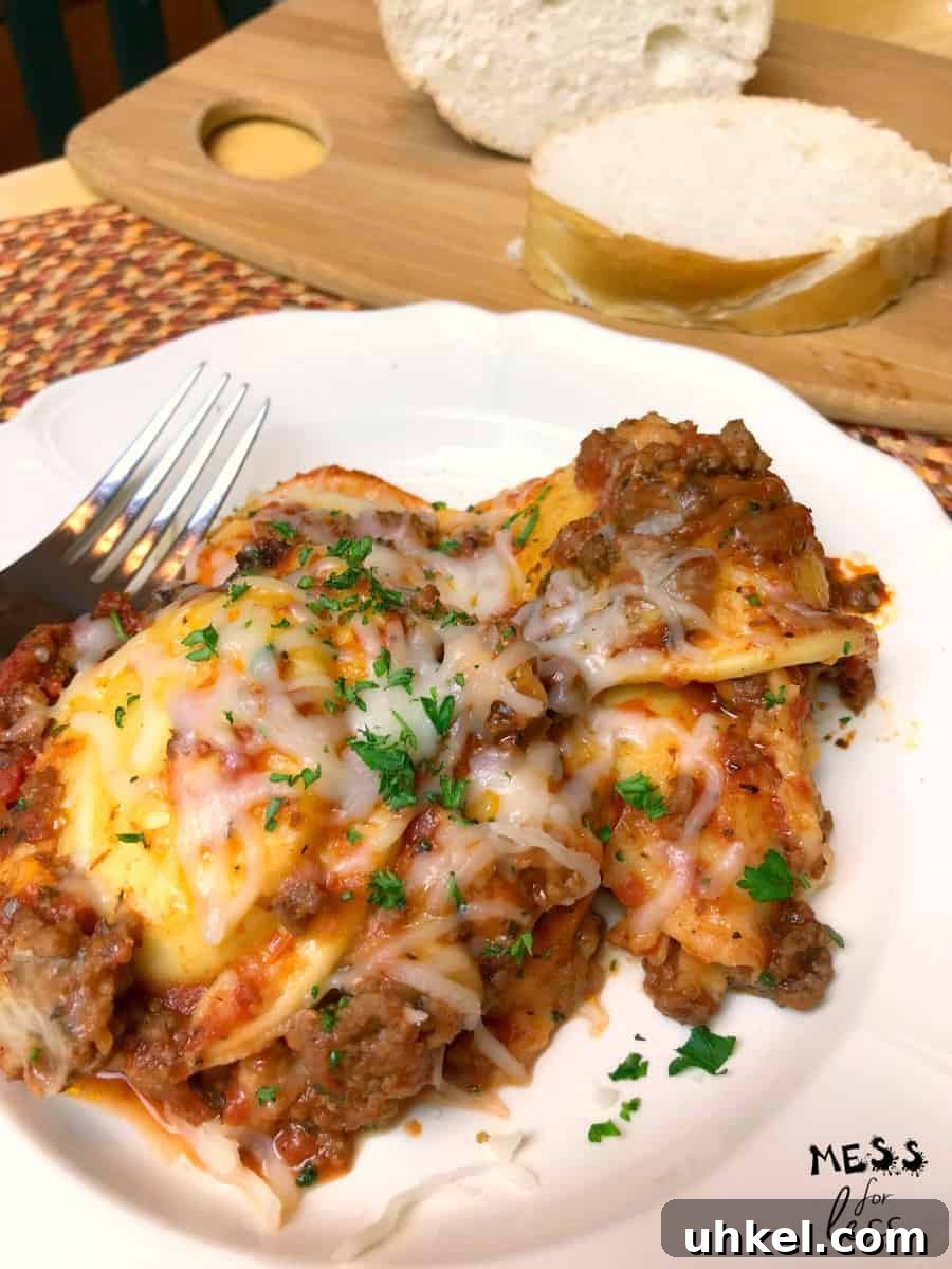 Slow-Cooker Ravioli Lasagna Recipe for Comforting Weeknight Meals 3 Ravioli Lasagna with meat sauce on a white plate