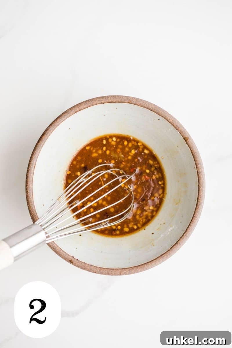 Gluten-Free Stir-Fry Sauce Recipe for Flavorful Quick Meals 5 A bowl with tamari with chili flakes.