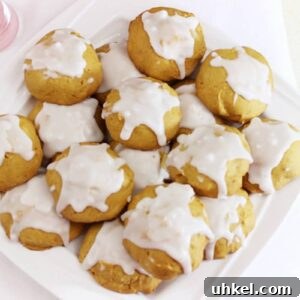 A batch of pumpkin cookies on a white plate.