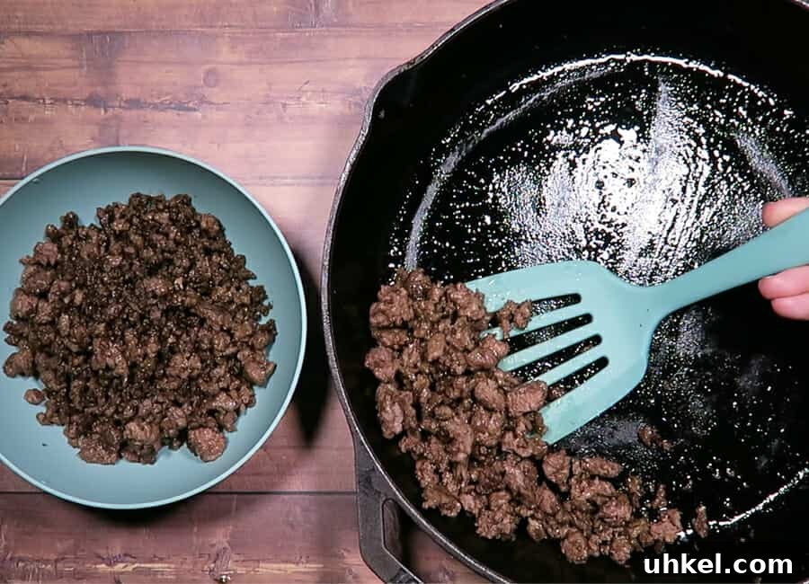 Creamy Ground Beef Stroganoff with Greek Yogurt 6 reserving the cooked ground beef into a bowl.