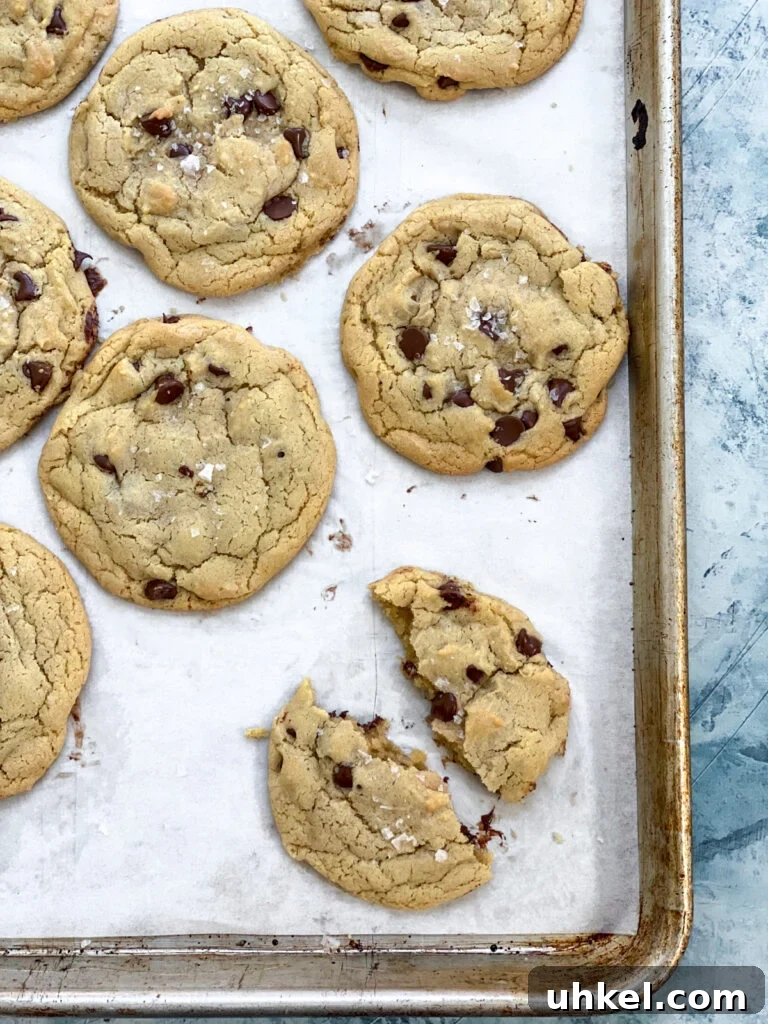 Chewy Chocolate Chip Cookies Without Butter: Soft & Updated Recipe 3 one broken cookie on a cookie sheet with others to the side