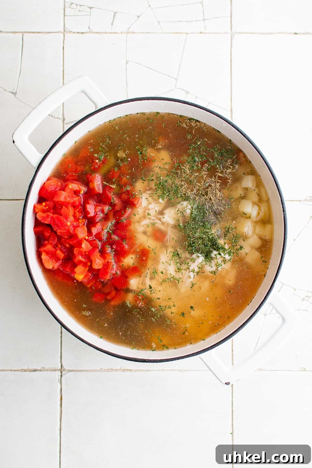 7-Can Soup Recipe: 7 Ingredients, 1 Delicious Meal 3 Broth and ingredients added to a pan of soup ingredients.