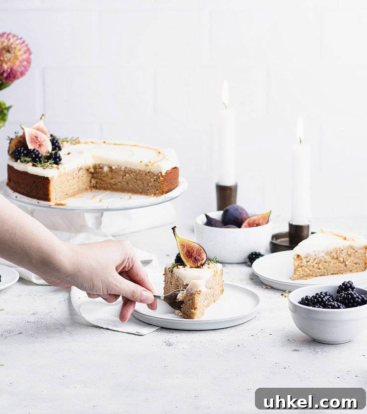 Top Fall Cakes to Bake This Season 5 Hand cutting into a plated slice of kyrdderkake with the larger cake, two lit taper candles and another slice slightly blurred in the background.
