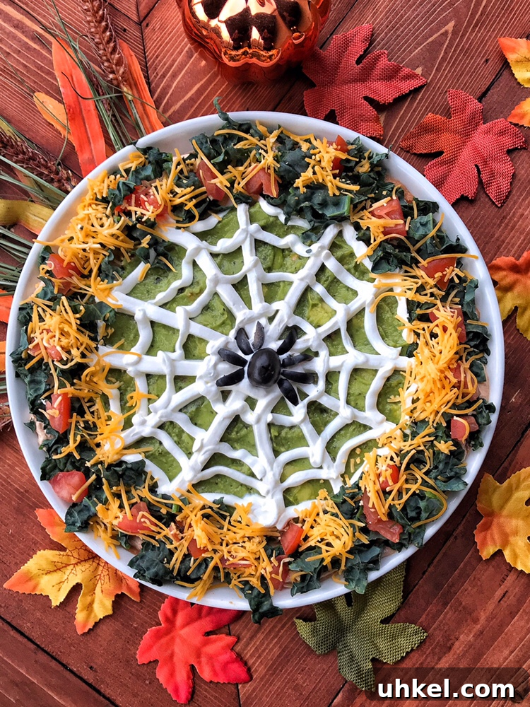 Spooky Onion Butter Burgers for Halloween Party Night 6 A Halloween guacamole dip with a sour cream spider web and an olive spider in the middle.