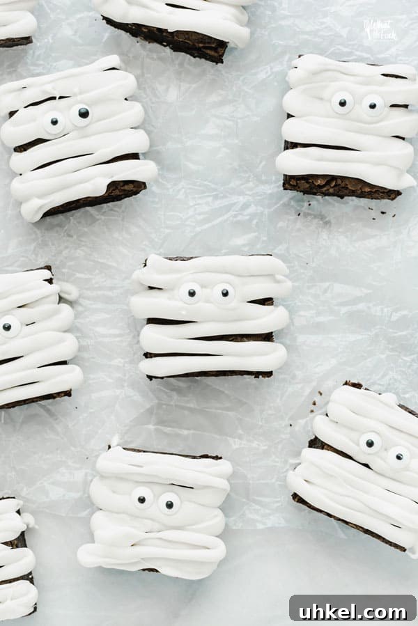 Gluten Free Mummy Brownies decorated for Halloween on crinkled wax paper