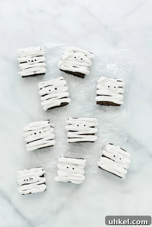 Overhead image of gluten free mummy brownies on top of a wax paper lined marble slab