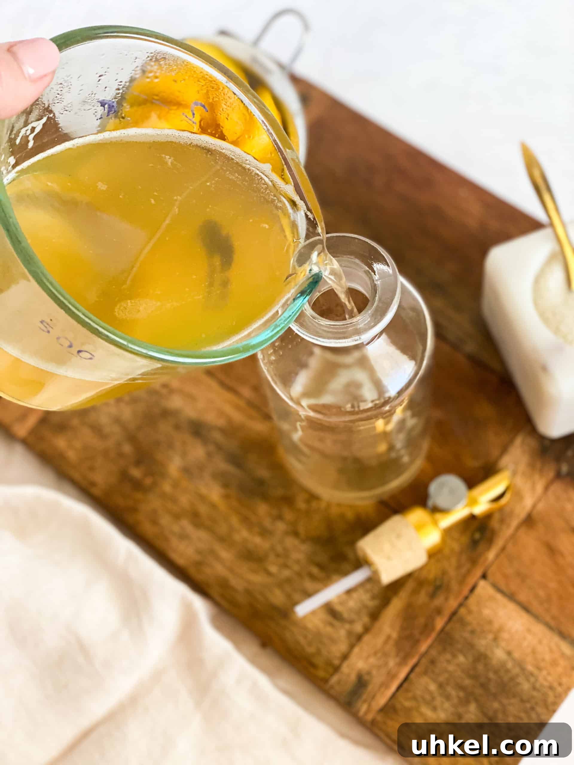 Homemade Peach Simple Syrup Recipe for Cocktails & Desserts 7 Peach Simple Syrup being poured into a glass