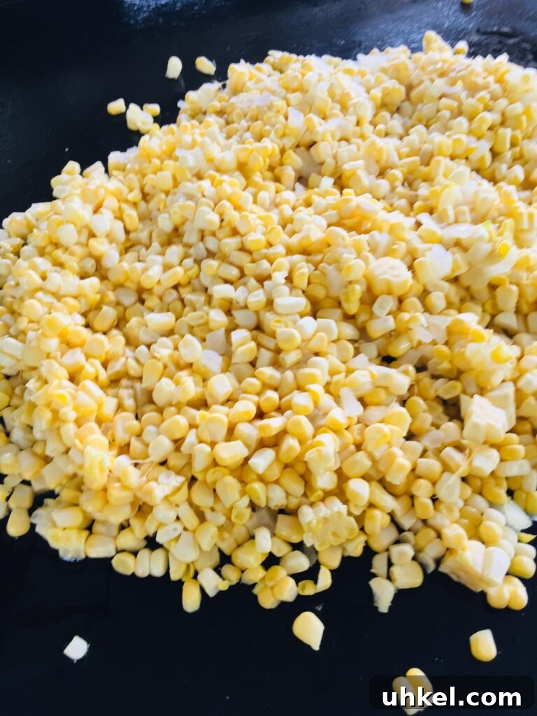 Blackstone Street Corn Dip Recipe for Grilled Skillet Corn 5 corn and onion cooking on the griddle