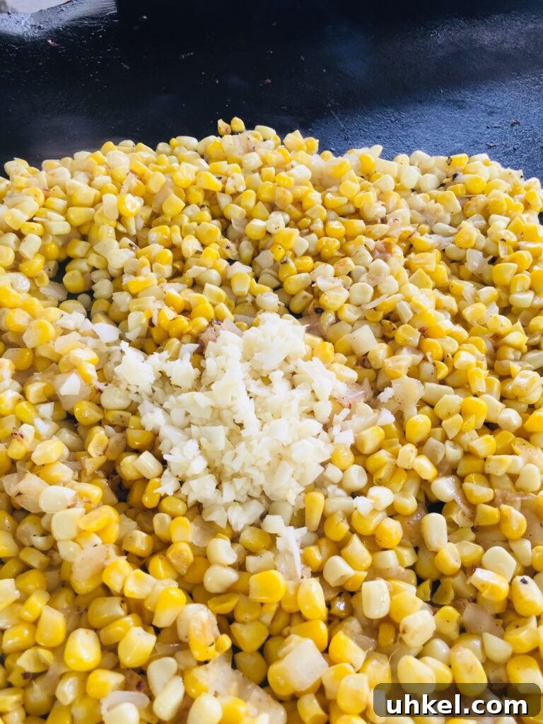 Blackstone Street Corn Dip Recipe for Grilled Skillet Corn 7 adding garlic to the corn